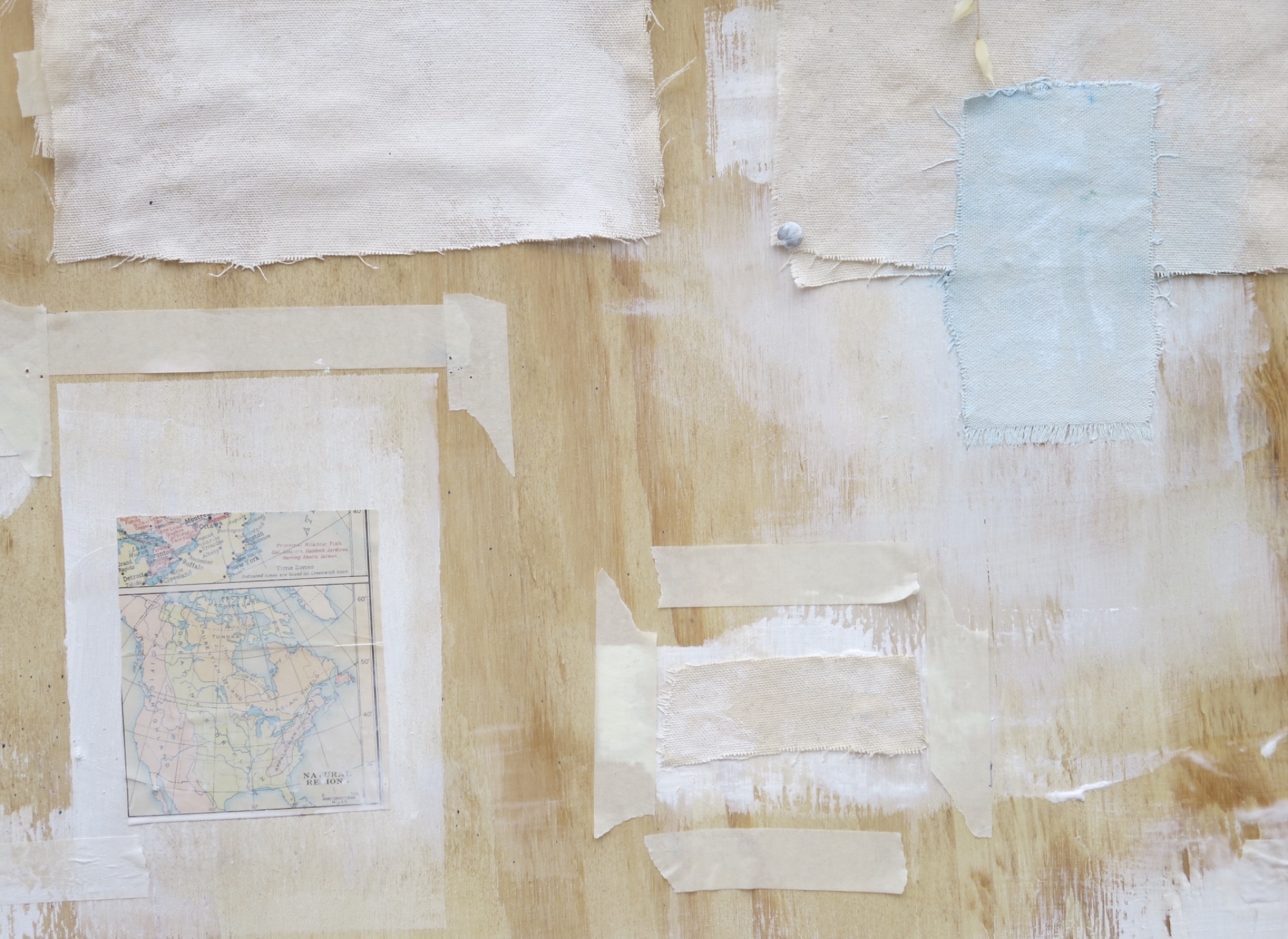 Mixed media on board: cream and white paper fragments with a pale blue rectangle at upper right.