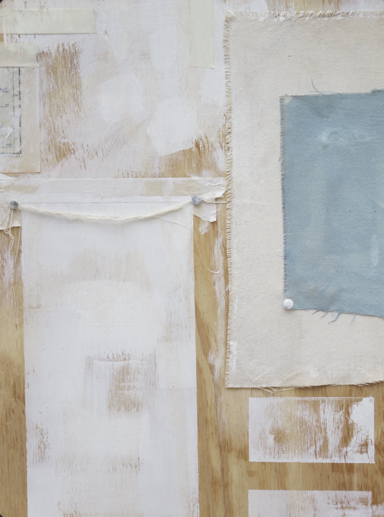Cream and white work with a pale blue panel and layers of pinned paper.