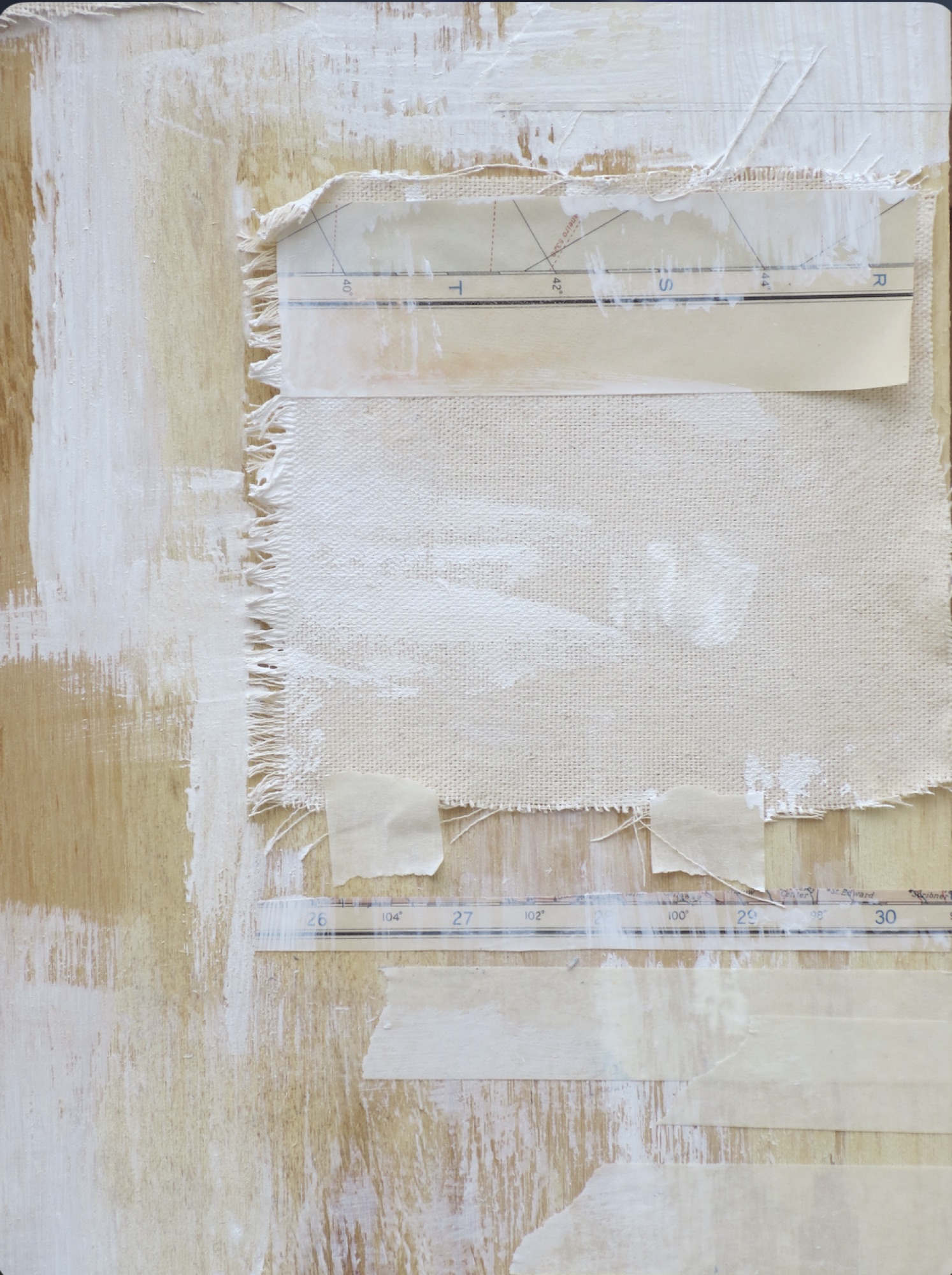 Layered white and cream paper with torn and frayed edges.