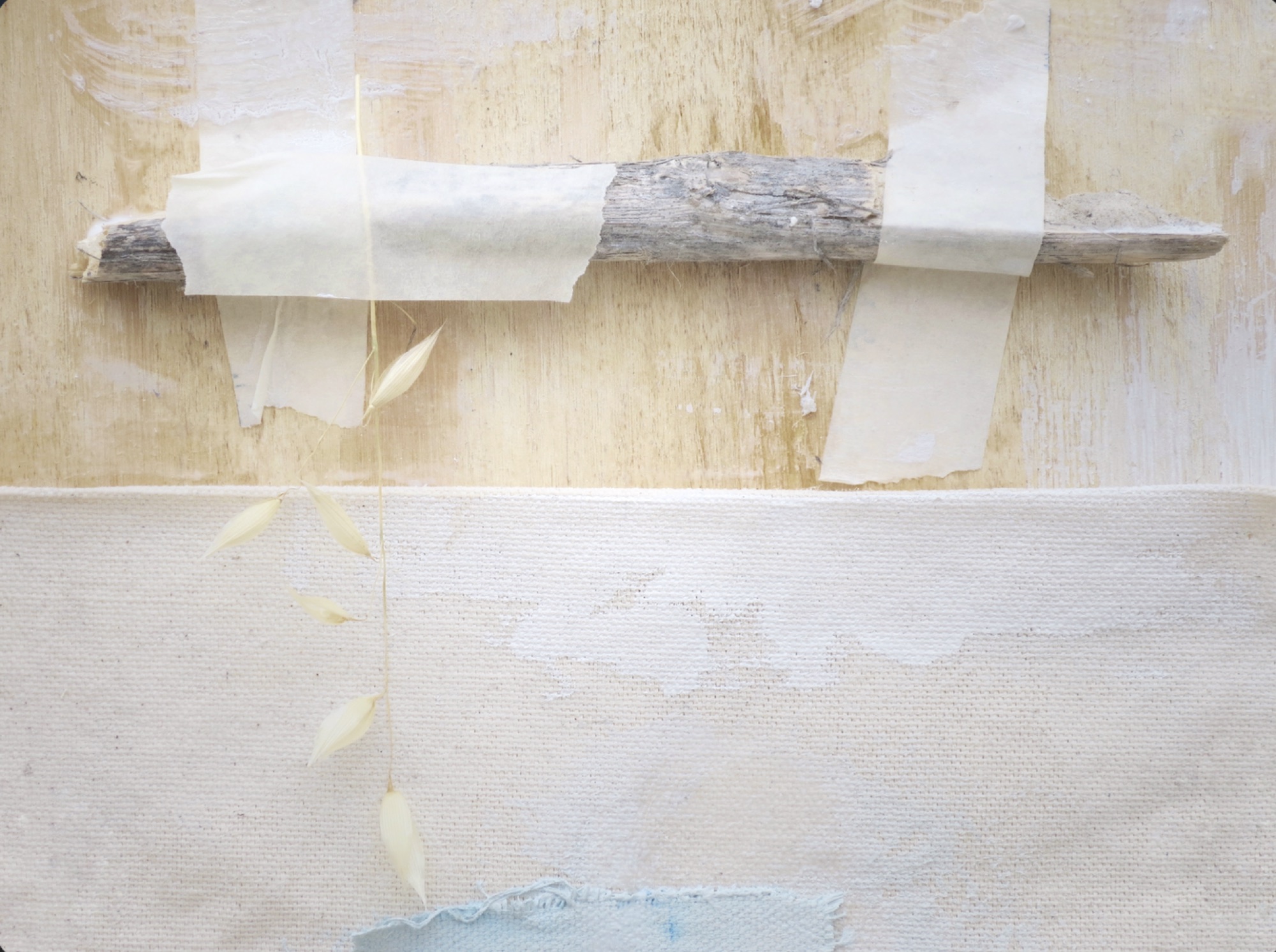 A rolled paper work resting on a pale surface.